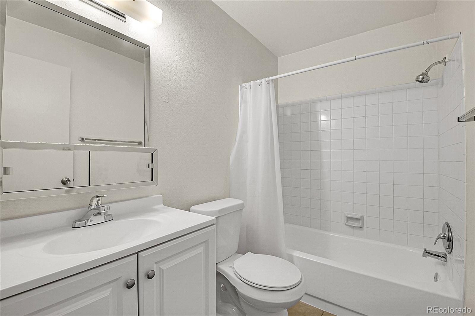 539 Wright Street, Unit 301 Lakewood, CO 80228 - Photo 20 of 32 a bathroom with a sink toilet and shower