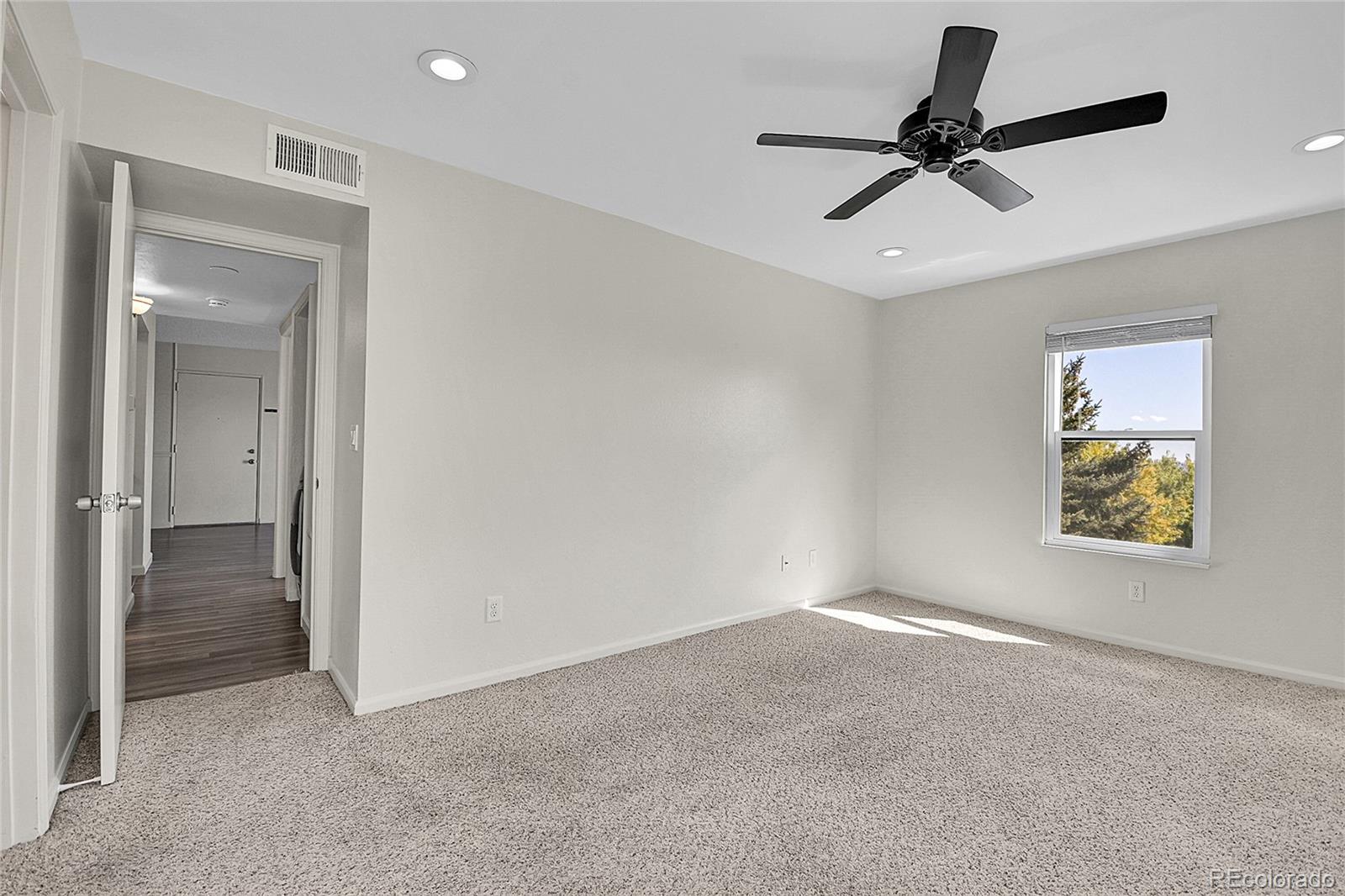 539 Wright Street, Unit 301 Lakewood, CO 80228 - Photo 28 of 32 a view of a livingroom with a ceiling fan and a window