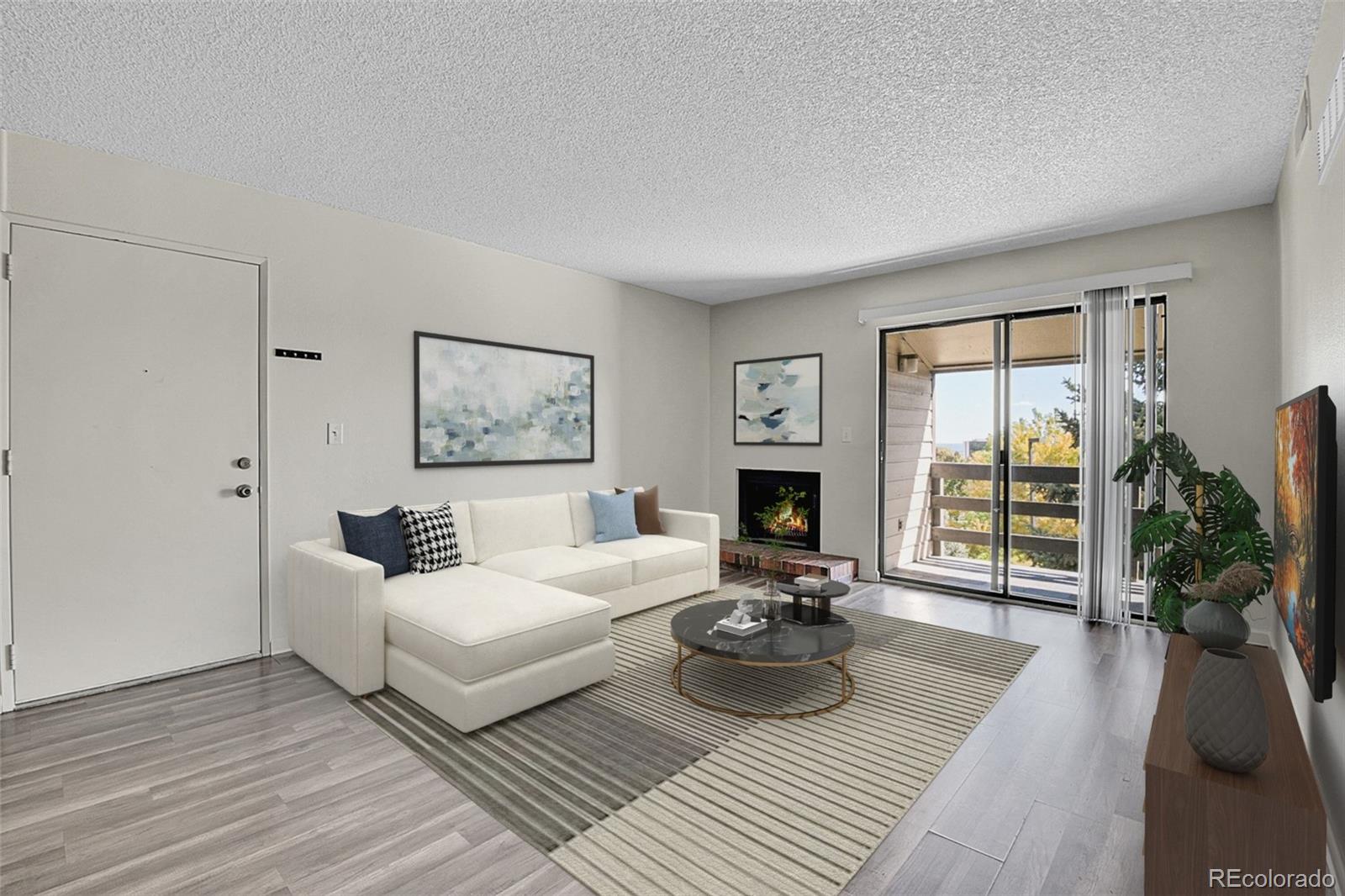 539 Wright Street, Unit 301 Lakewood, CO 80228 - Photo 6 of 32 a living room with furniture and a fireplace