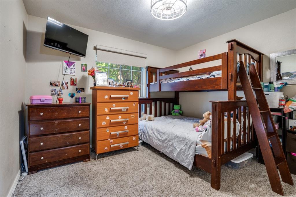 1211 Maple Terrace Drive Mansfield, TX 76063 - Photo 16 of 26 a bedroom with a bed and flat screen tv