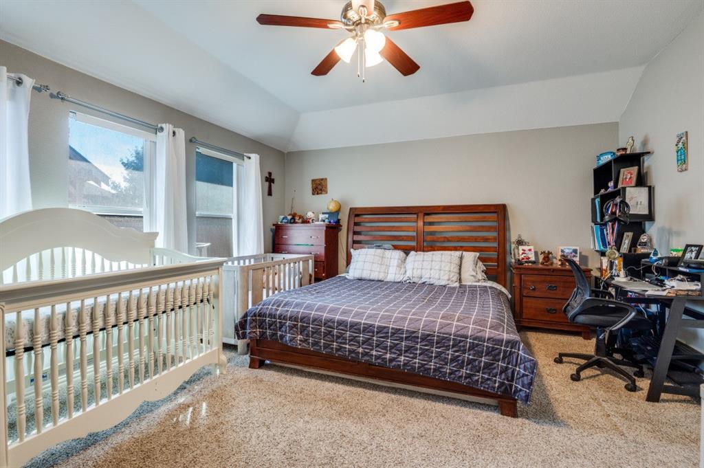 1211 Maple Terrace Drive Mansfield, TX 76063 - Photo 19 of 26 a bedroom with a bed and a chandelier