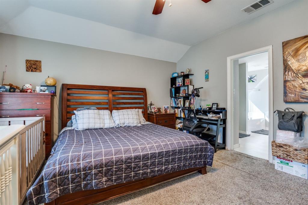 1211 Maple Terrace Drive Mansfield, TX 76063 - Photo 20 of 26 a bedroom with a bed and wooden floor