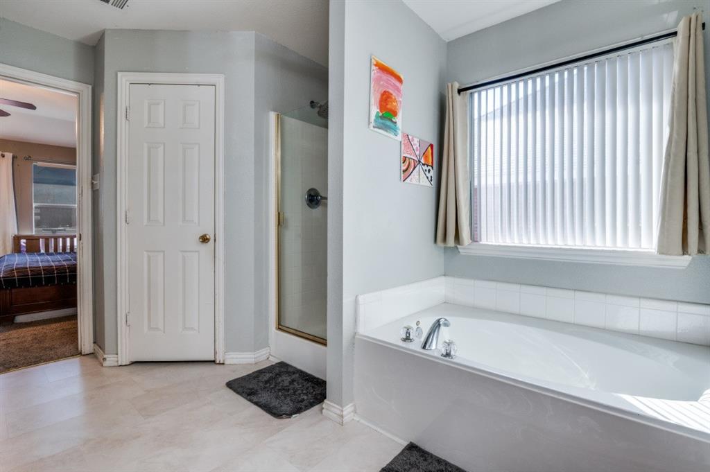 1211 Maple Terrace Drive Mansfield, TX 76063 - Photo 21 of 26 a bathroom with a bathtub and a shower