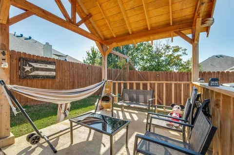 a view of a chairs and table in the patio