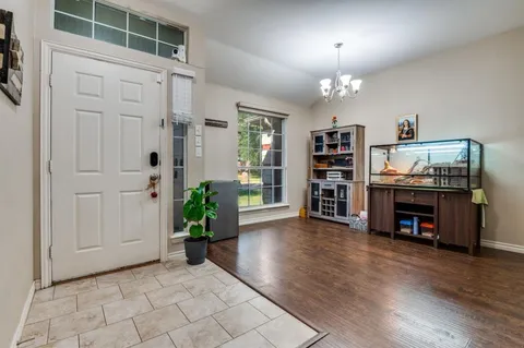 an empty room with furniture and wooden floor