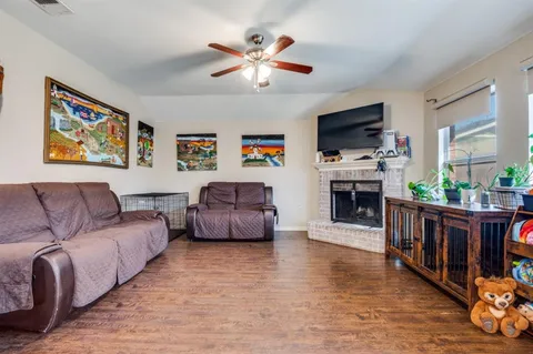 a living room with furniture fireplace and flat screen tv