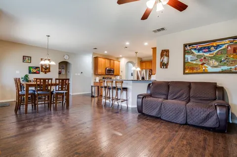 a living room with furniture and wooden floor