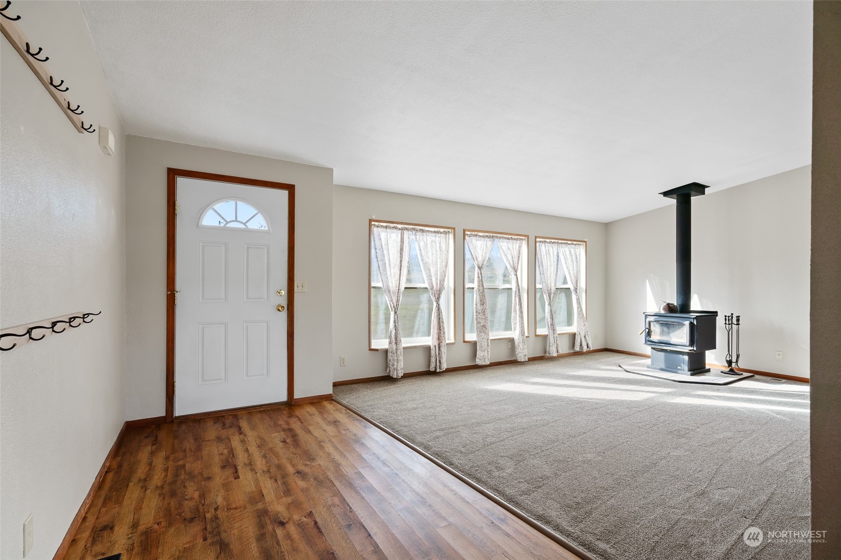 1963 Freimuth Road Selah, WA 98942 - Photo 4 of 33 a view of an empty room with a window and wooden floor