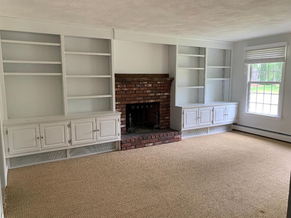 5 Countryside Way Andover, MA 01810 - Photo 12 of 41 a view of an empty room with a fireplace and a window
