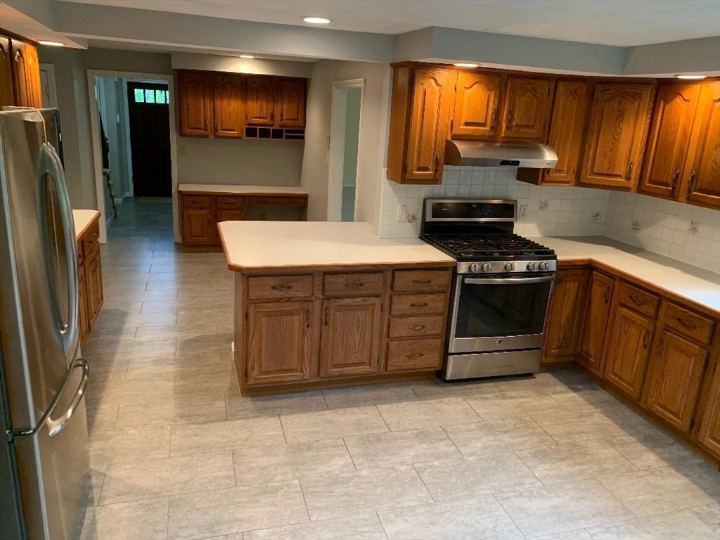 5 Countryside Way Andover, MA 01810 - Photo 2 of 41 a kitchen with stainless steel appliances granite countertop a stove a sink and a refrigerator