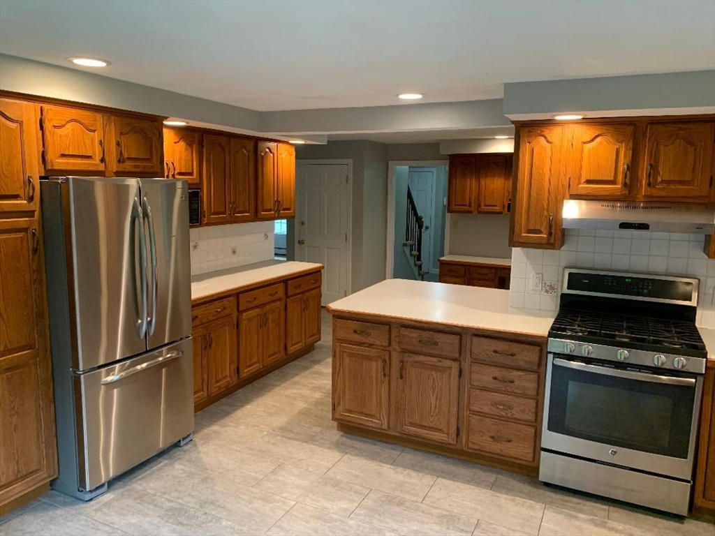 5 Countryside Way Andover, MA 01810 - Photo 3 of 41 a kitchen with stainless steel appliances granite countertop a refrigerator stove and sink