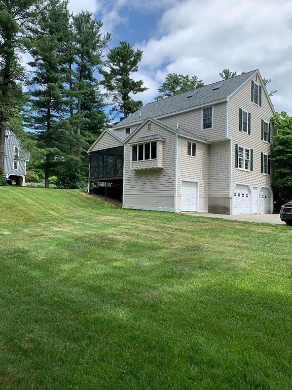 5 Countryside Way Andover, MA 01810 - Photo 35 of 41 a front view of house with yard and trees in the background