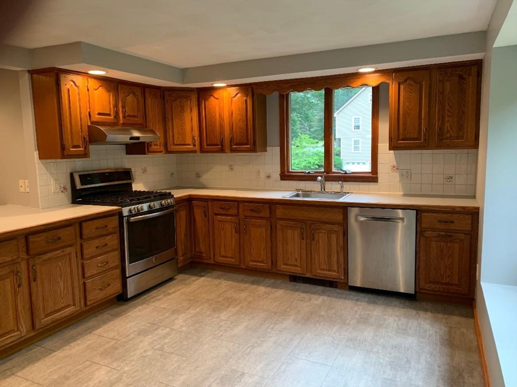 5 Countryside Way Andover, MA 01810 - Photo 4 of 41 a kitchen with stainless steel appliances granite countertop a stove a sink dishwasher and a microwave oven