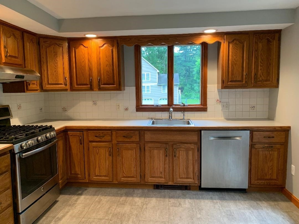 5 Countryside Way Andover, MA 01810 - Photo 5 of 41 a kitchen with stainless steel appliances granite countertop a stove a sink and a microwave