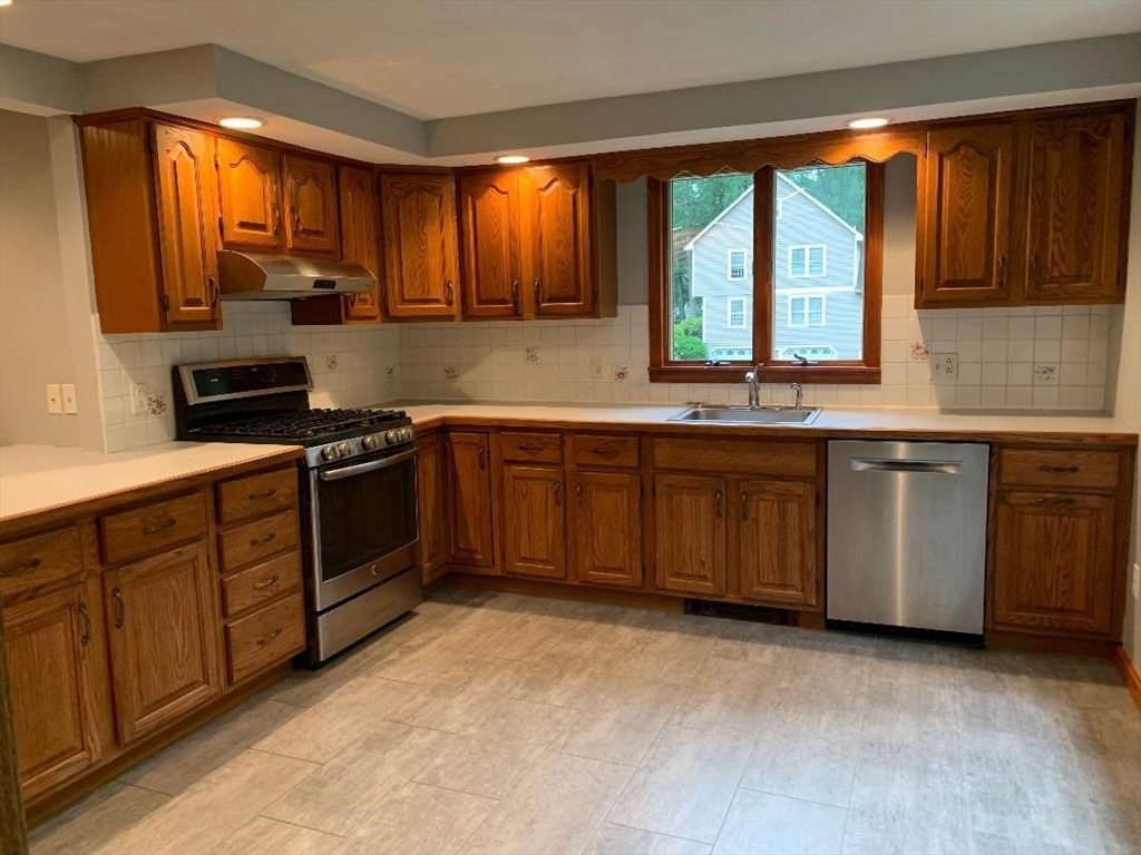 5 Countryside Way Andover, MA 01810 - Photo 6 of 41 a kitchen with stainless steel appliances granite countertop wooden cabinets sink and window