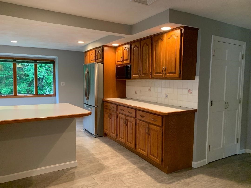 5 Countryside Way Andover, MA 01810 - Photo 9 of 41 a kitchen with stainless steel appliances granite countertop a sink and a refrigerator