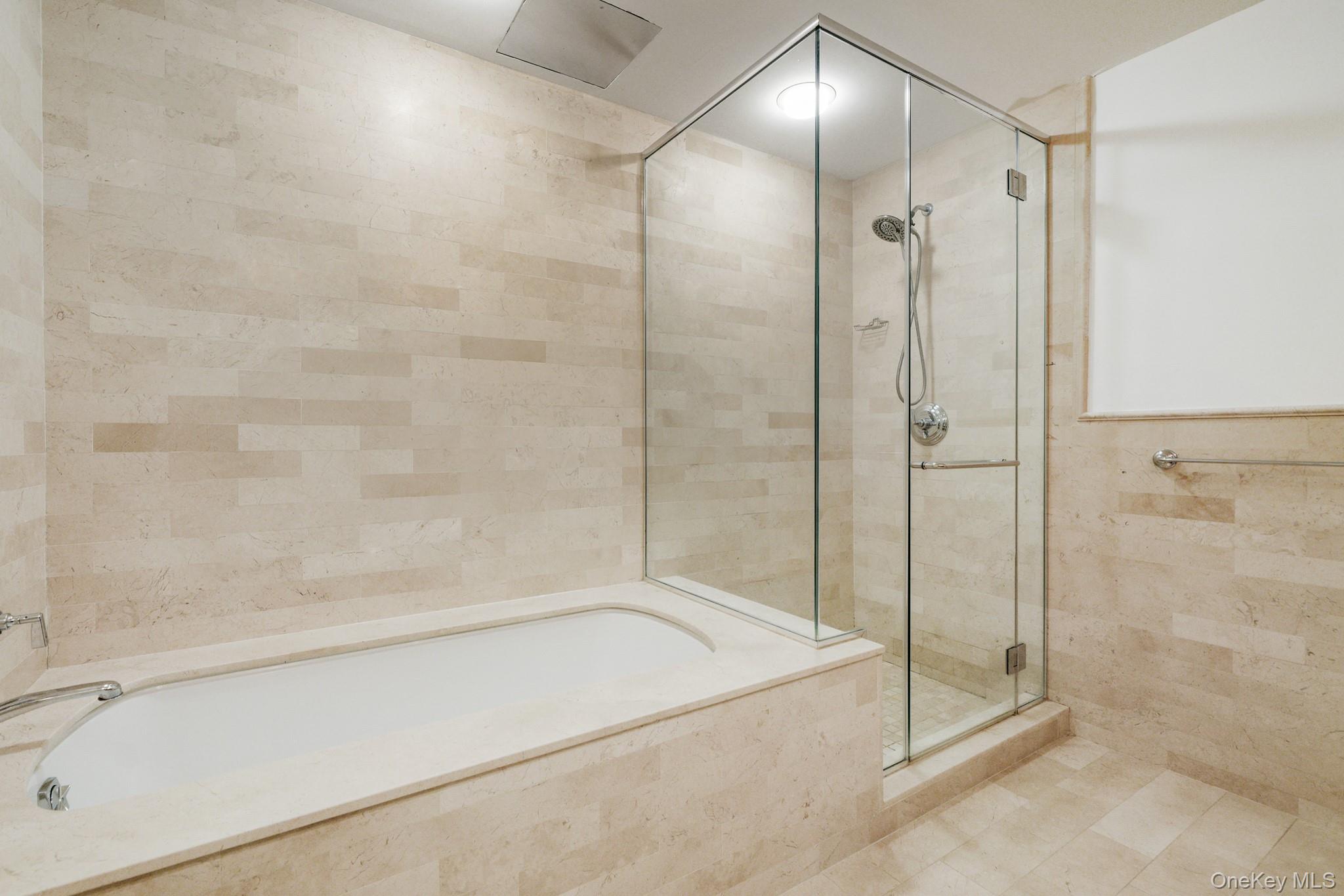1 Renaissance Square, Unit 15E White Plains, NY 10601 - Photo 14 of 27 a bathroom with a bathtub and a shower