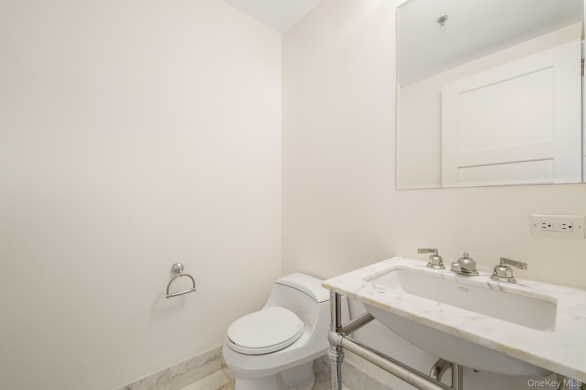 1 Renaissance Square, Unit 15E White Plains, NY 10601 - Photo 19 of 27 a bathroom with a sink and a toilet
