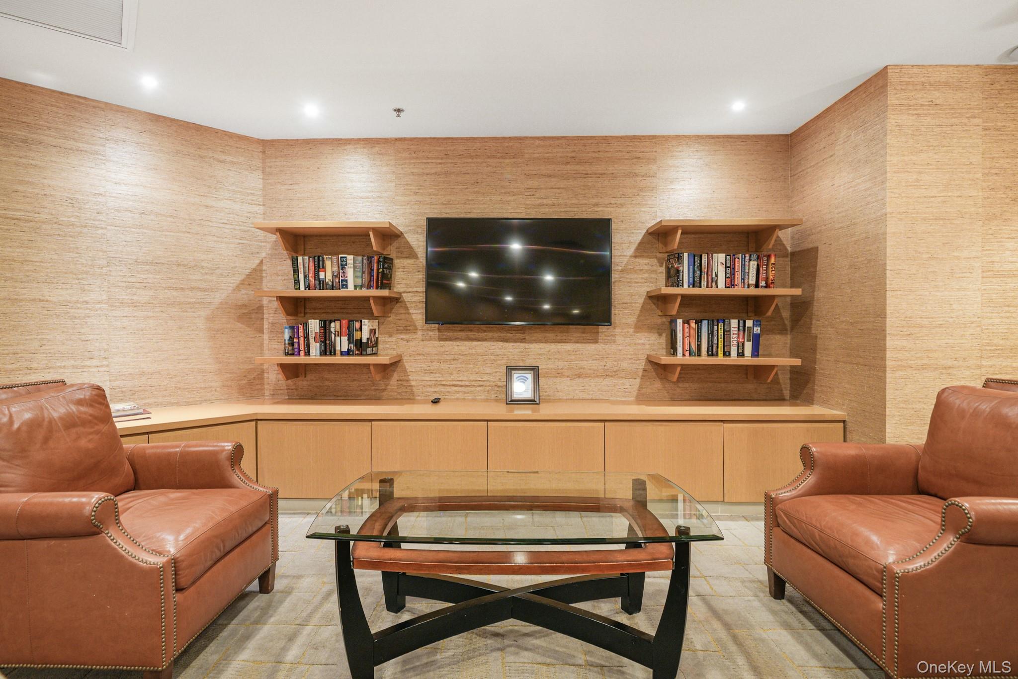1 Renaissance Square, Unit 15E White Plains, NY 10601 - Photo 25 of 27 a living room with furniture and a flat screen tv