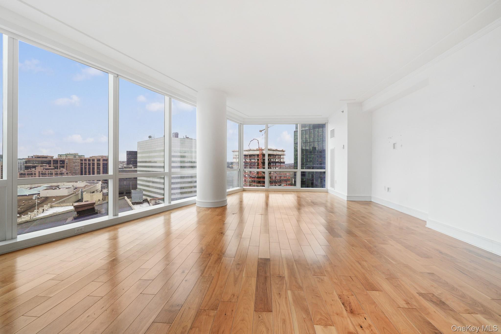 1 Renaissance Square, Unit 15E White Plains, NY 10601 - Photo 4 of 27 wooden floor in an empty room with a window