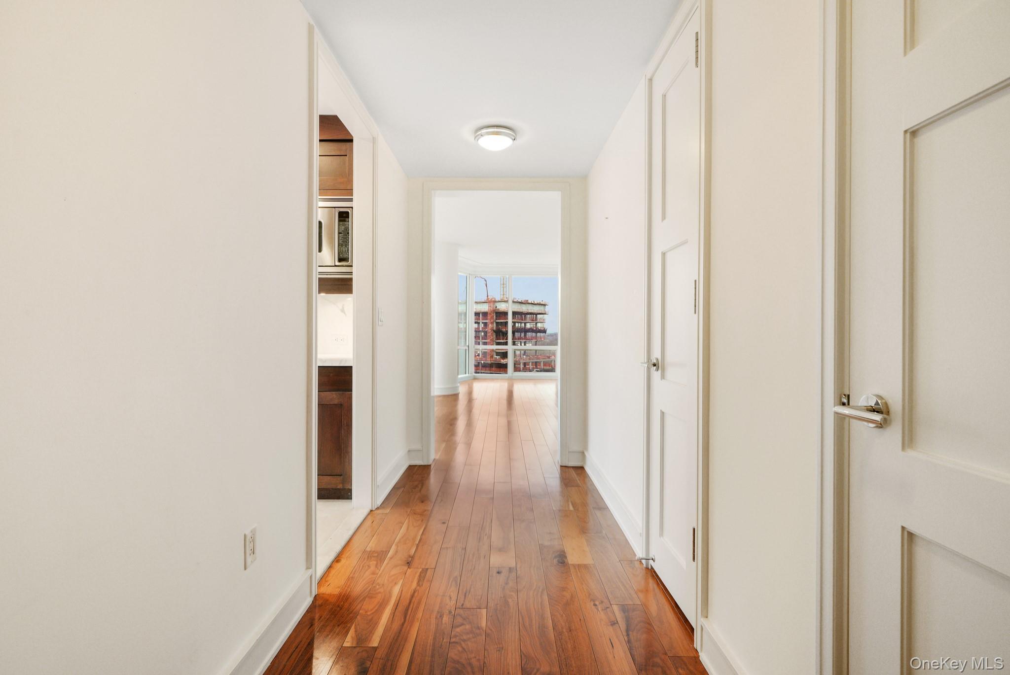 1 Renaissance Square, Unit 15E White Plains, NY 10601 - Photo 10 of 27 a view of a hallway with wooden floor