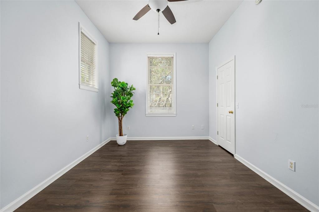 5213 Southwest 91 Terrace, Unit B Gainesville, FL 32608 - Photo 21 of 38 a view of an empty room with wooden floor and a window