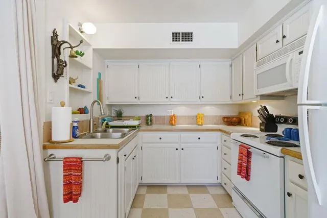 a kitchen with a sink stove and cabinets