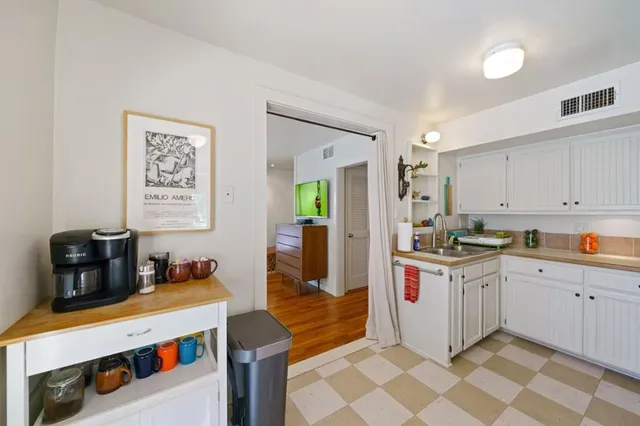 a kitchen with a sink and wooden cabinets