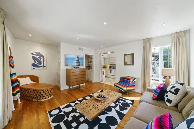 a bedroom with furniture and a wooden floor