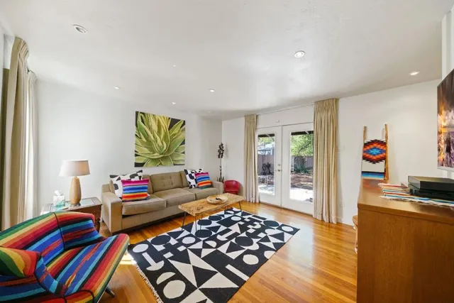 a living room with rug furniture and a window