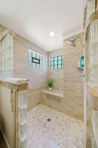 a bathroom with a bathtub and shower