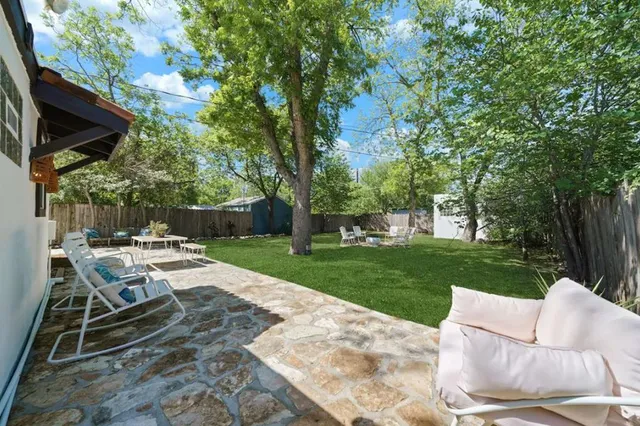 a view of backyard with seating area and green space