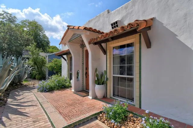 a view of a house with potted plants