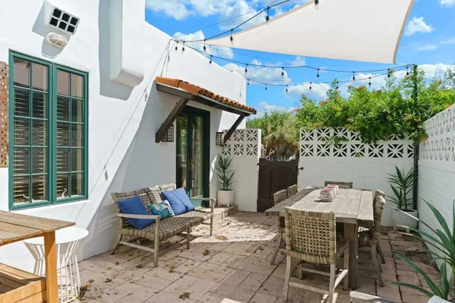 a view of backyard with outdoor seating and plants