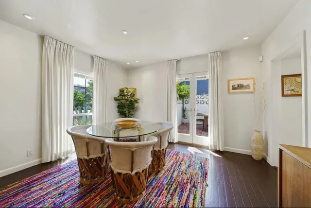 a dining room with furniture and wooden floor