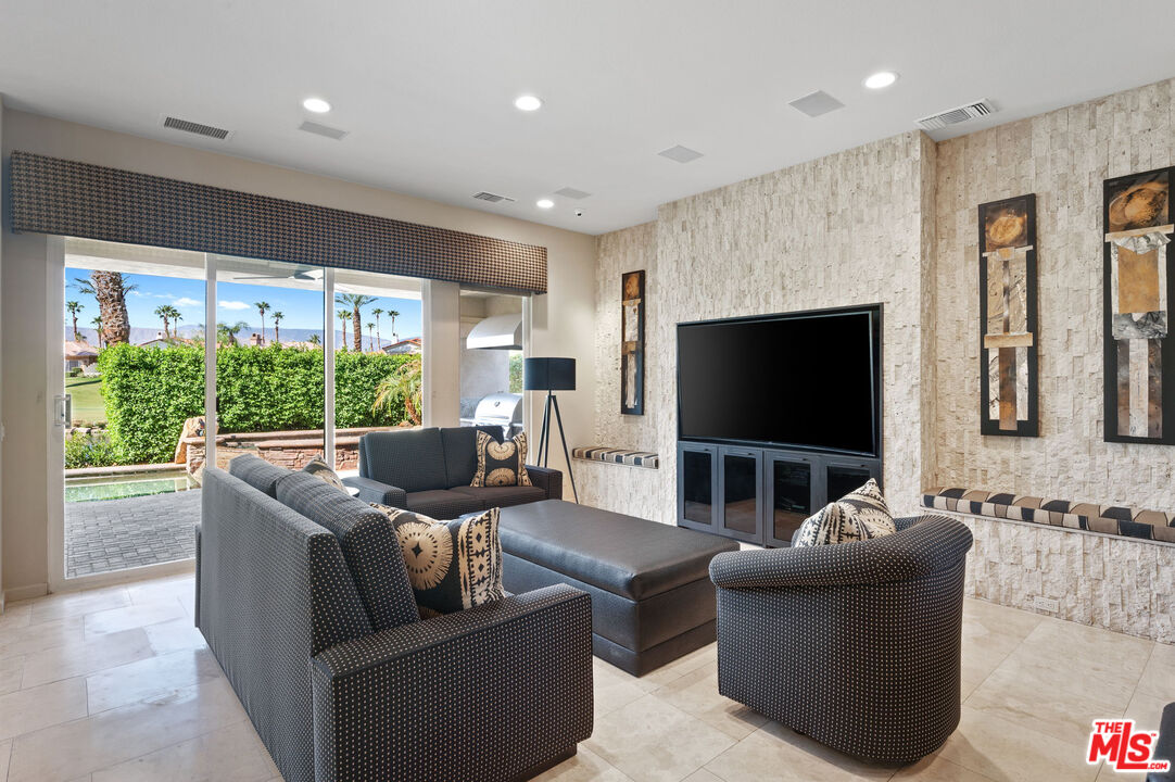 331 Tomahawk Drive Palm Desert, CA 92211 - Photo 12 of 40 a living room with furniture and a flat screen tv