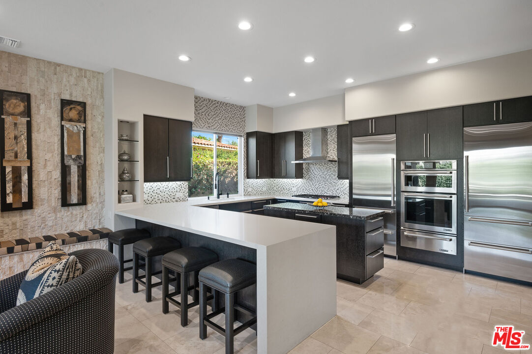 331 Tomahawk Drive Palm Desert, CA 92211 - Photo 14 of 40 a large kitchen with stainless steel appliances lots of counter space and a sink