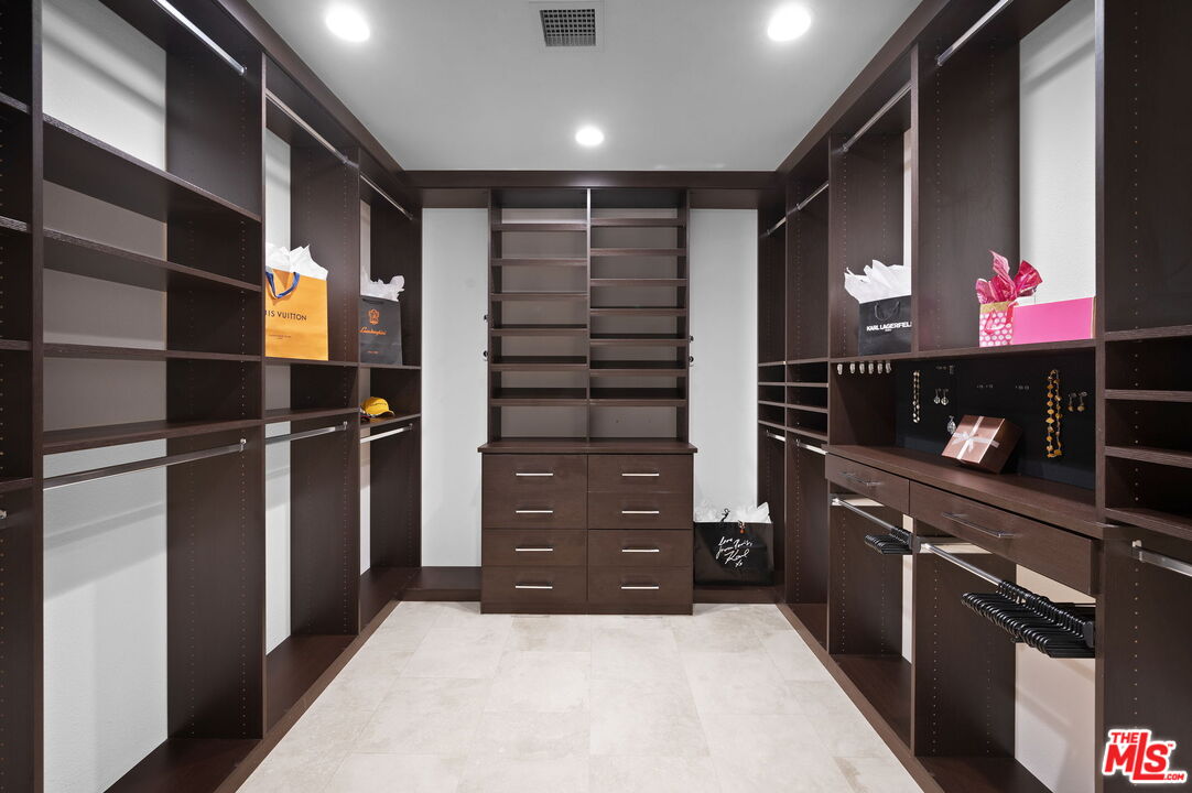 331 Tomahawk Drive Palm Desert, CA 92211 - Photo 19 of 40 a kitchen with a refrigerator and cabinets