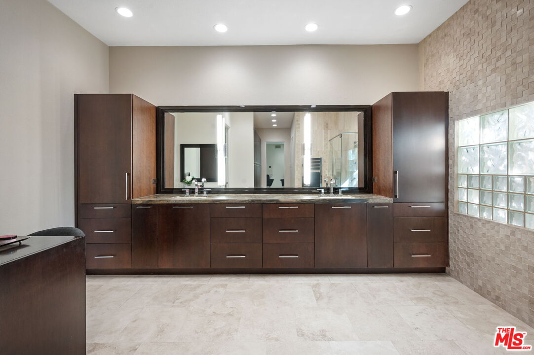 331 Tomahawk Drive Palm Desert, CA 92211 - Photo 20 of 40 a bathroom with a sink and a large mirror