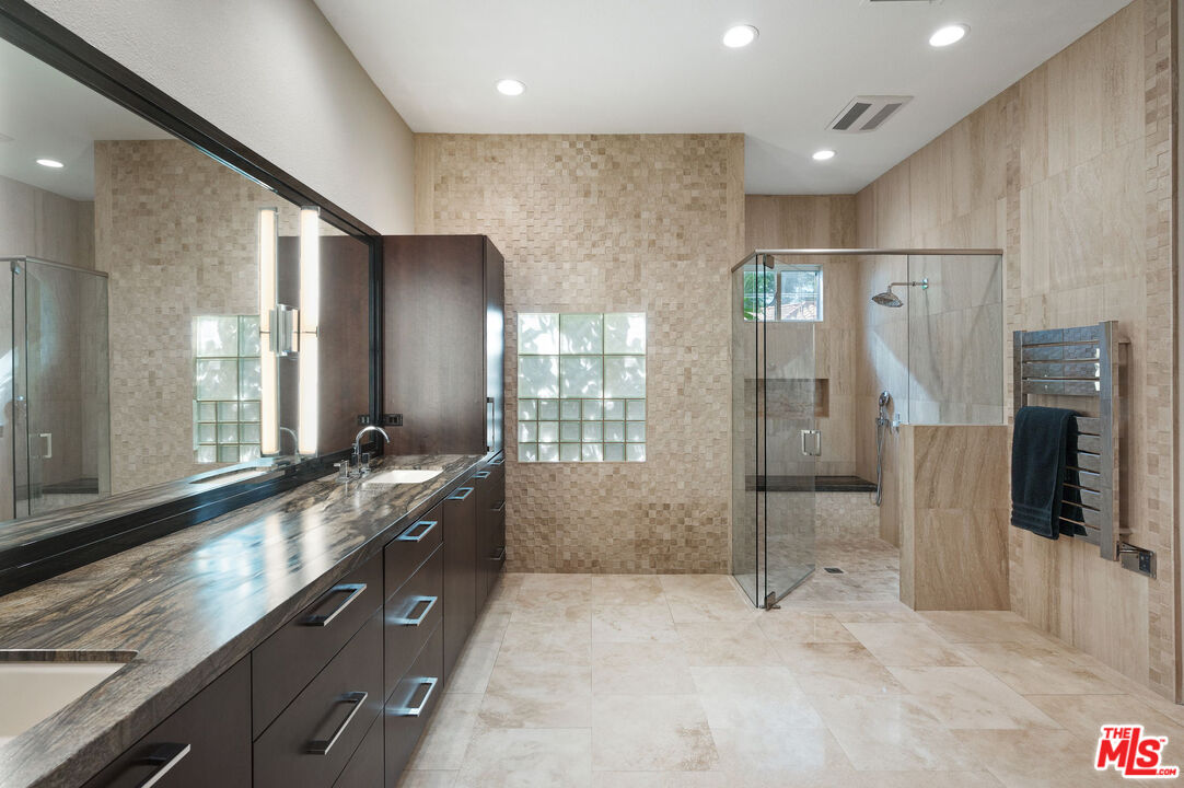 331 Tomahawk Drive Palm Desert, CA 92211 - Photo 22 of 40 a large bathroom with a granite countertop sink mirror and shower
