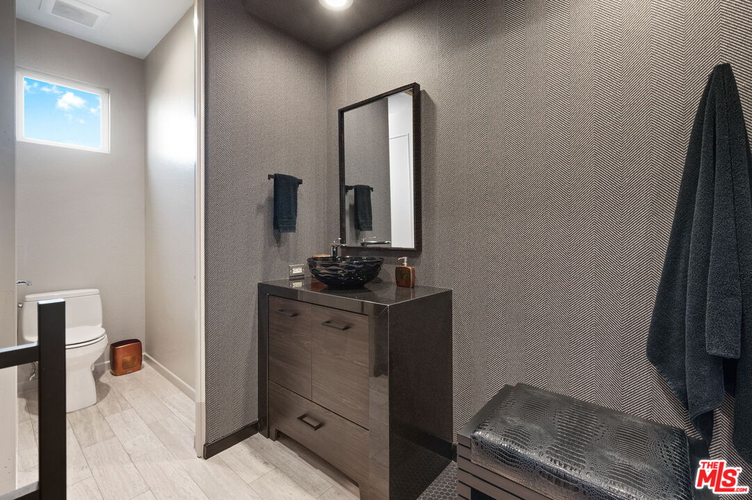 331 Tomahawk Drive Palm Desert, CA 92211 - Photo 26 of 40 a bathroom with a sink and a mirror