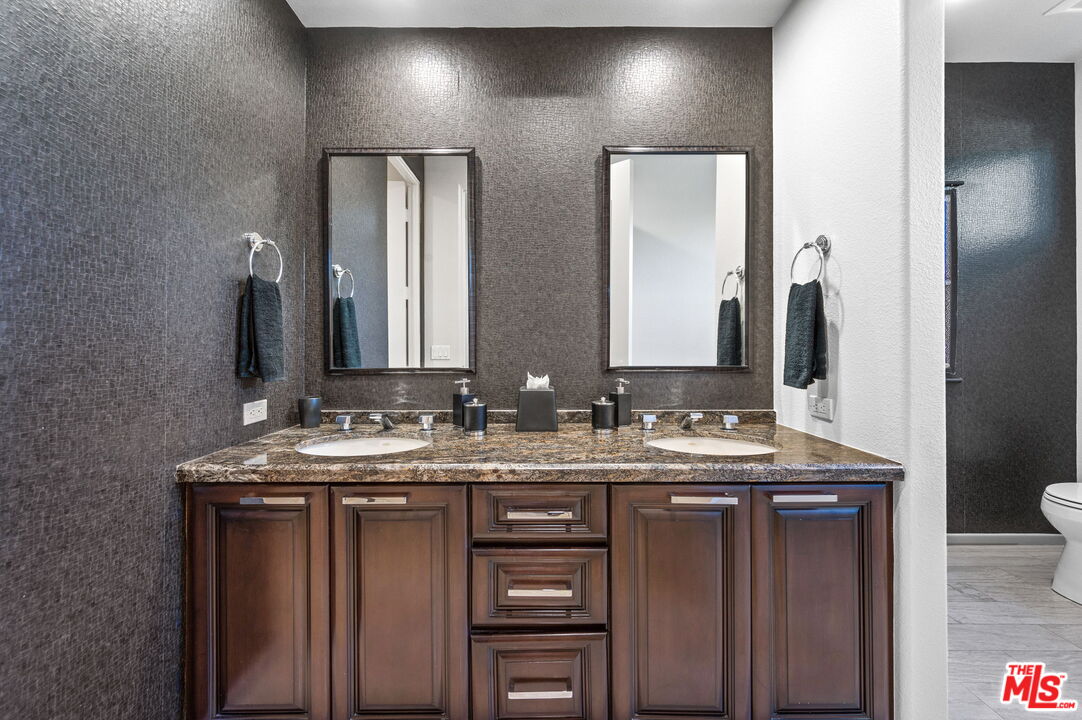 331 Tomahawk Drive Palm Desert, CA 92211 - Photo 29 of 40 a bathroom with a double vanity sink and a mirror
