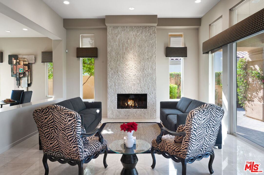 331 Tomahawk Drive Palm Desert, CA 92211 - Photo 8 of 40 a living room with furniture and a fireplace