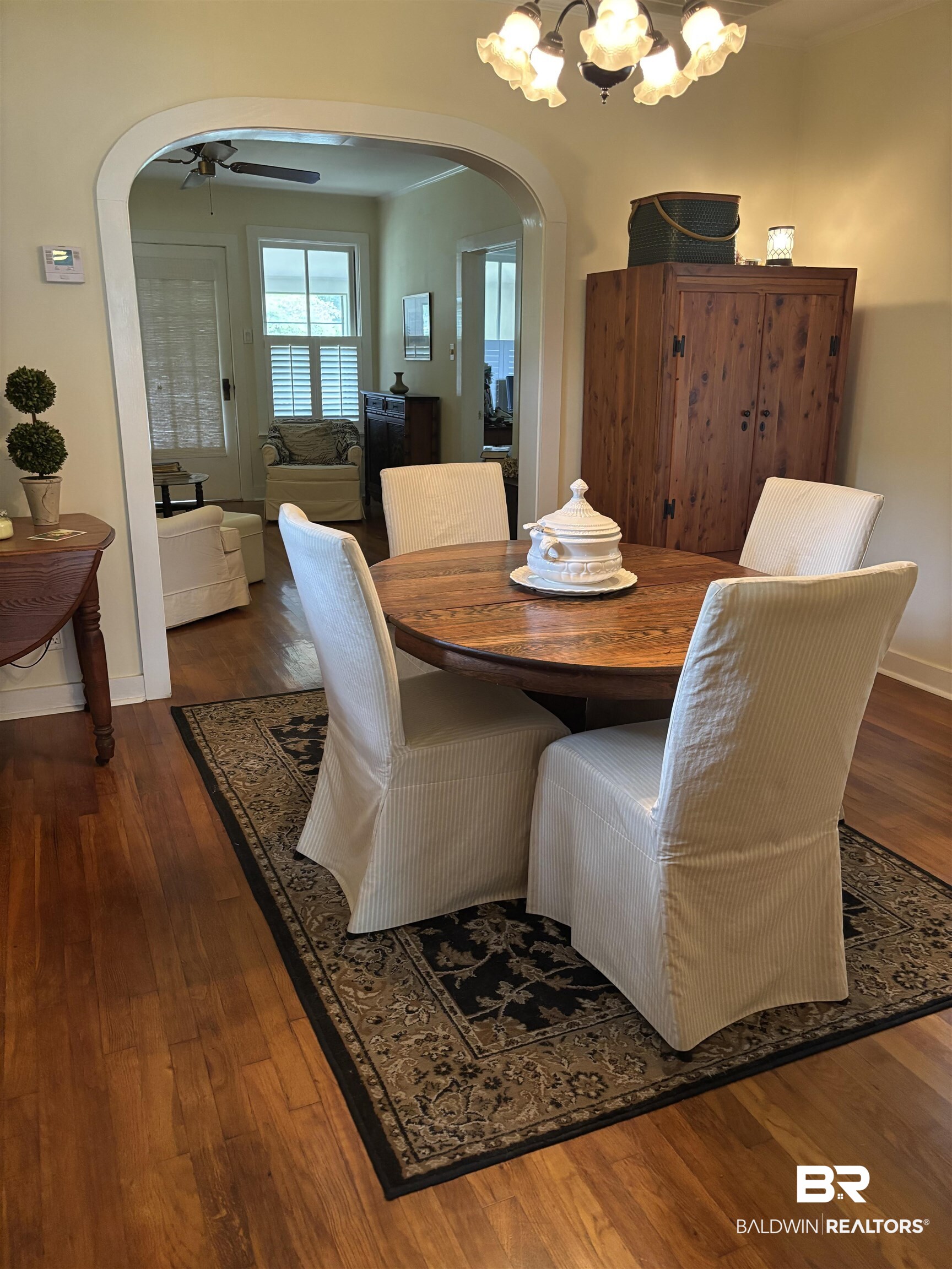 216 West Orange Avenue Foley, AL 36535 - Photo 17 of 37 Dining space featuring arched walkways, a ceiling fan, wood finished floors, and baseboards