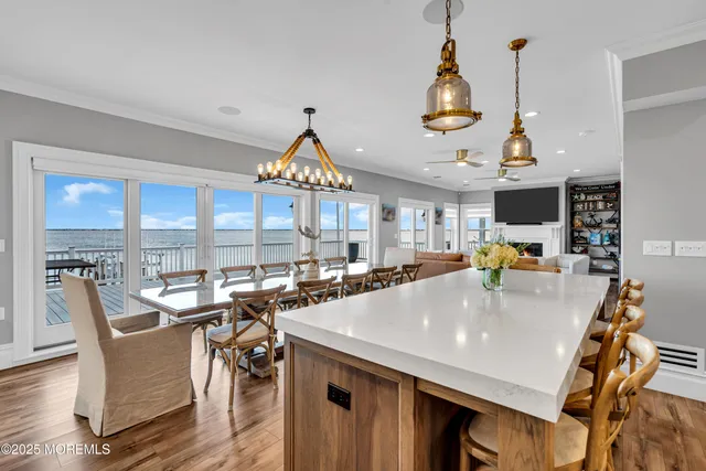 a very nice looking dining room with a large window and stainless steel appliances