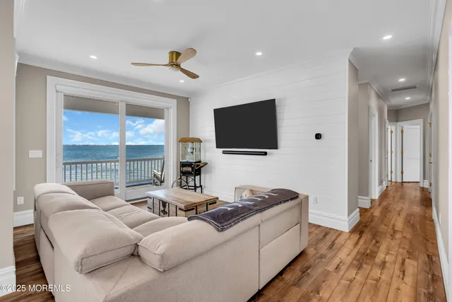 a view of a kitchen area with furniture and wooden floor