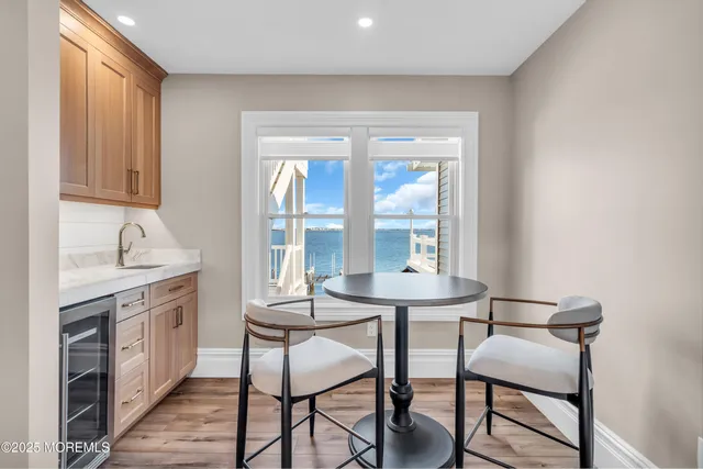 a living room with furniture a chandelier and a wooden floor