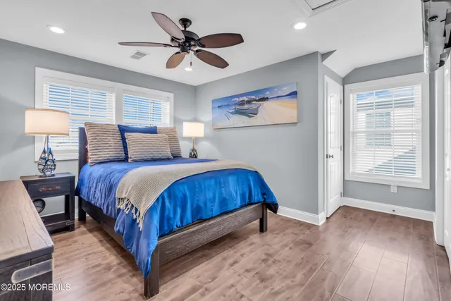 a bedroom with two beds and a large window