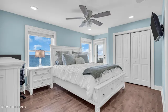 a bedroom with a bed and large window