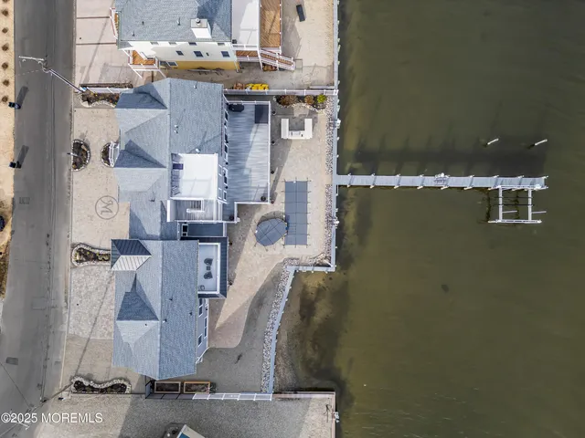 an aerial view of a house with a mountain